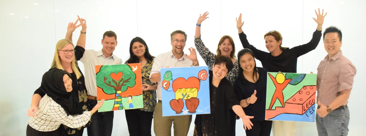 Art Jamming participants celebrating finished canvases